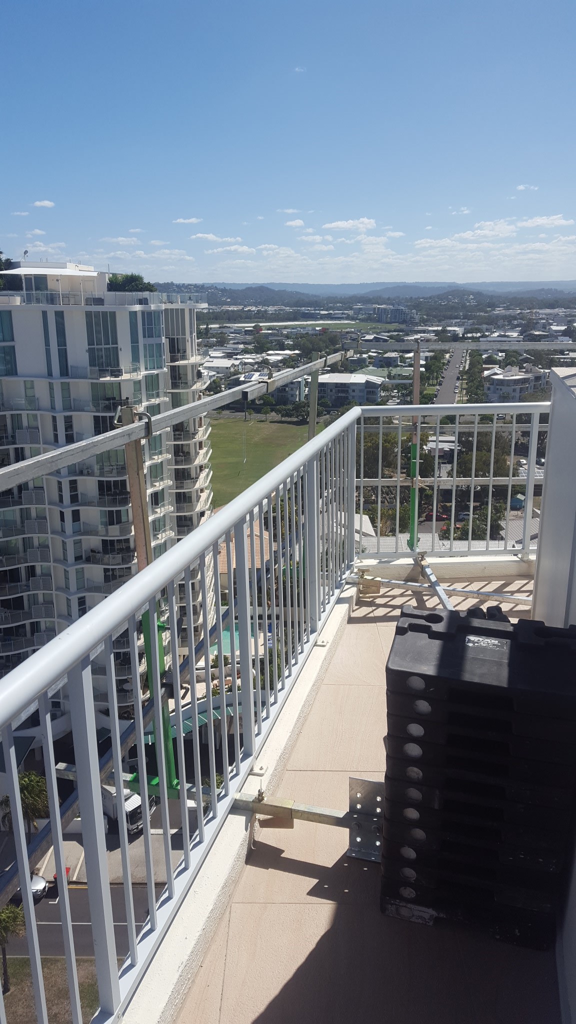 RISSafety height safety equipment on a balcony overlooking a Queensland cityscape.