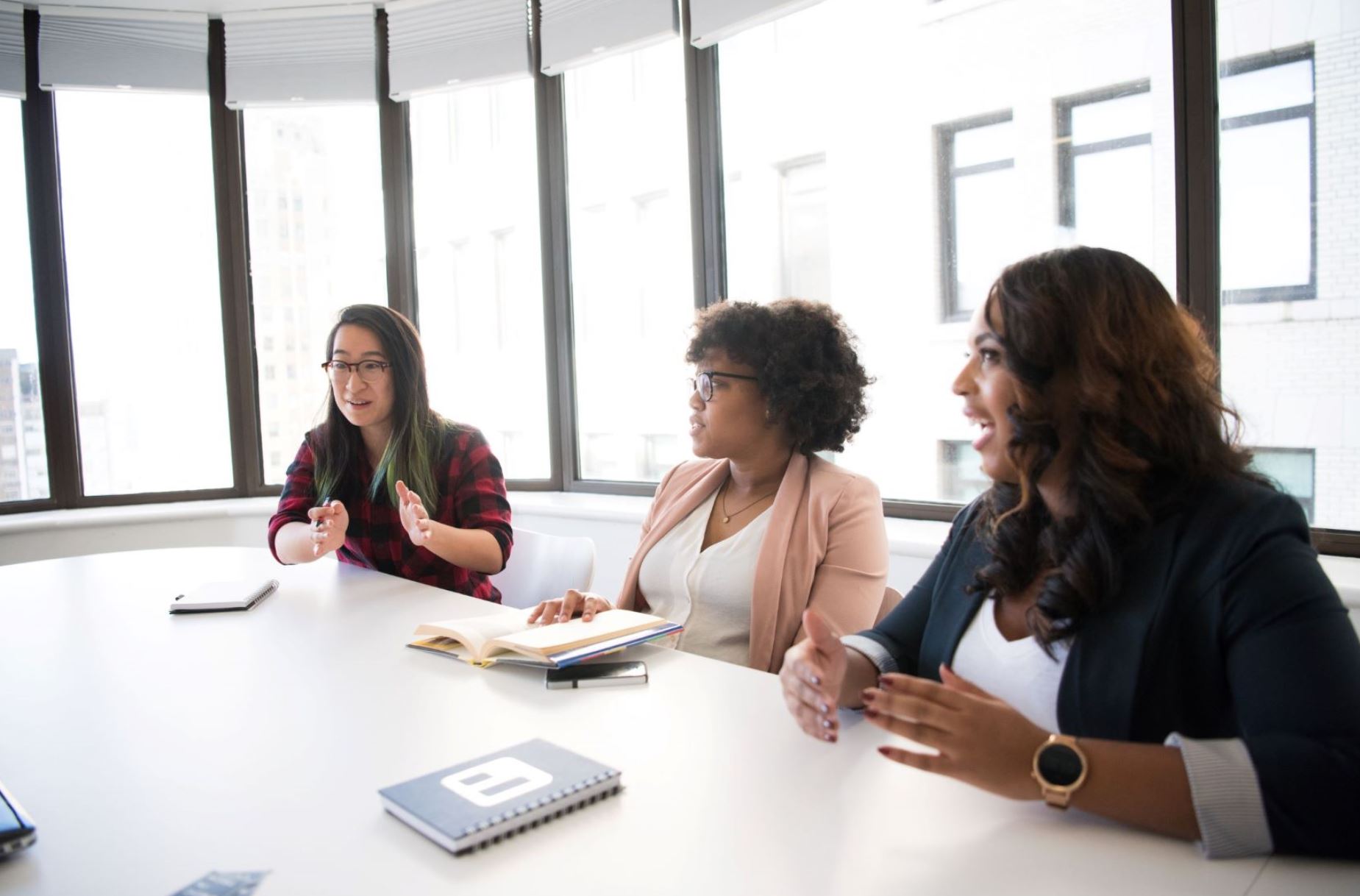 Women in a business meeting at RISSafety, discussing career opportunities and company culture.