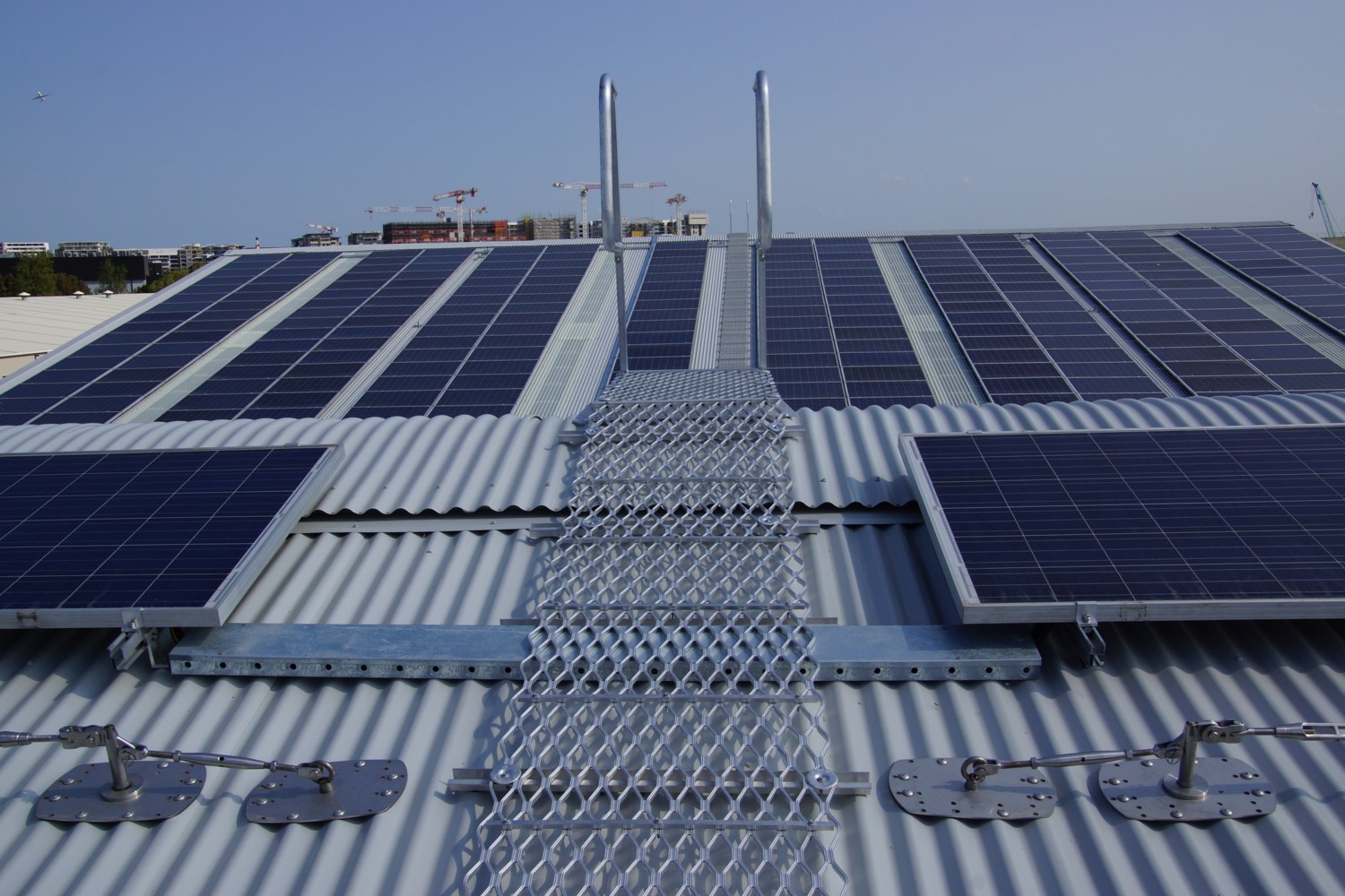 Aluminium walkway and safety handrails for safe solar panel access on a roof.