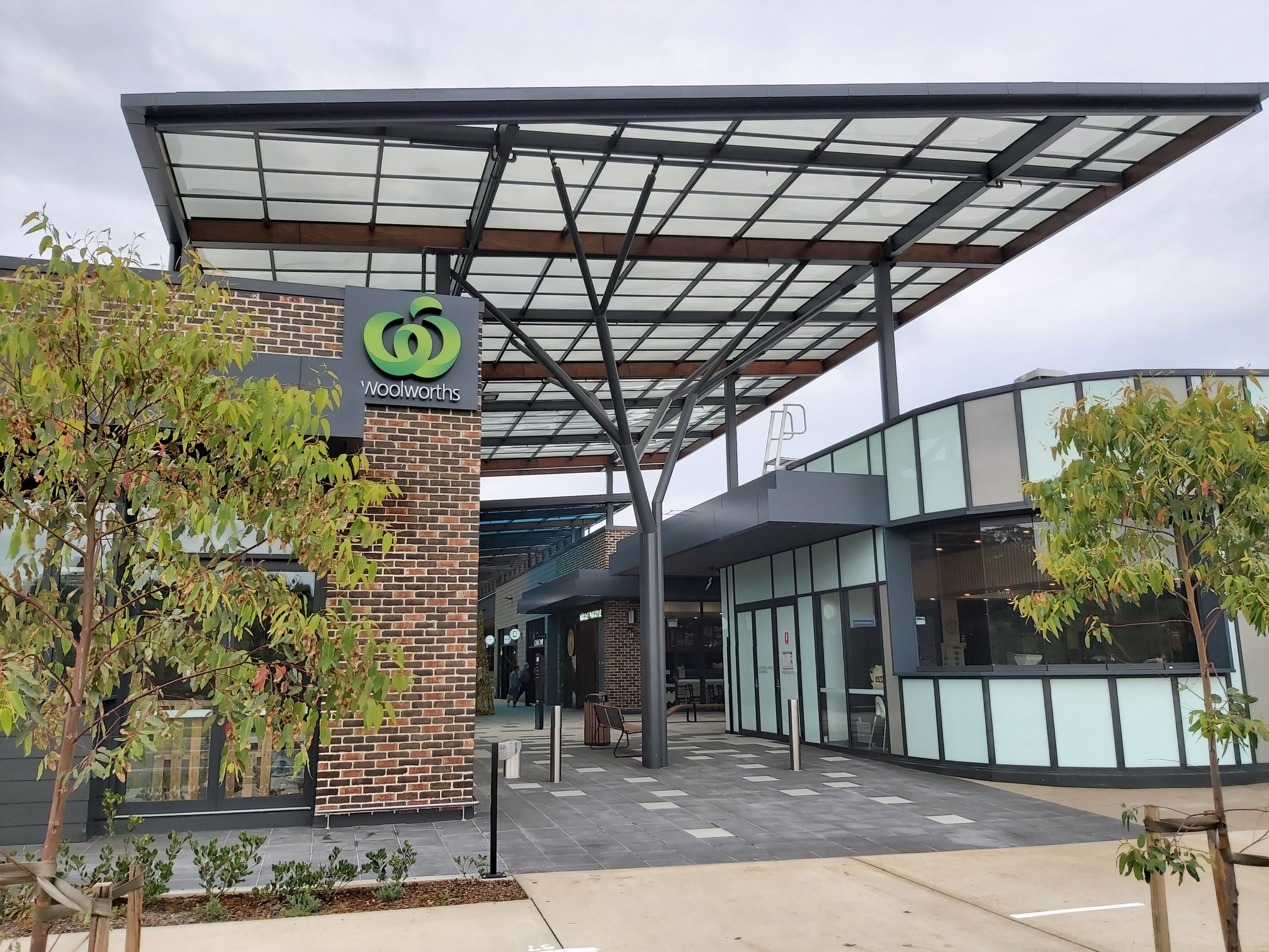 Caddens Corner Shopping Centre roof featuring lightweight polycarbonate structure and Woolworths signage, showcasing roof safety system design.