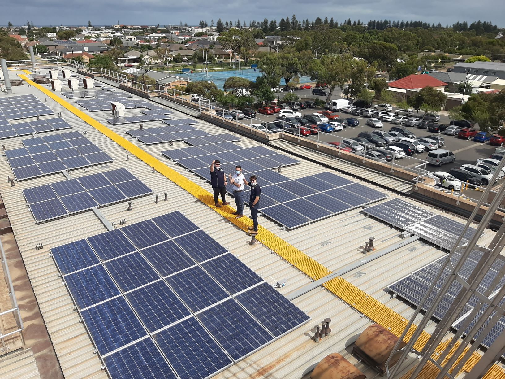 RISSafety team inspecting roof access system and solar panels on Western Hospital roof.