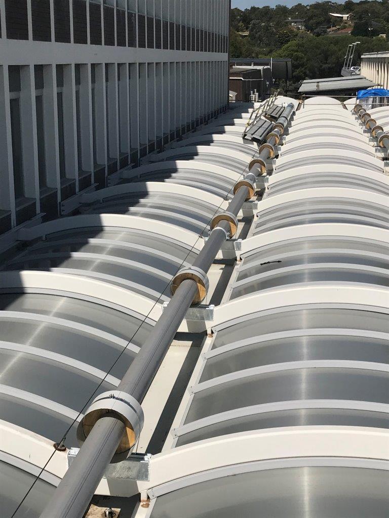 Safety systems and height safety equipment on a curved building roof.