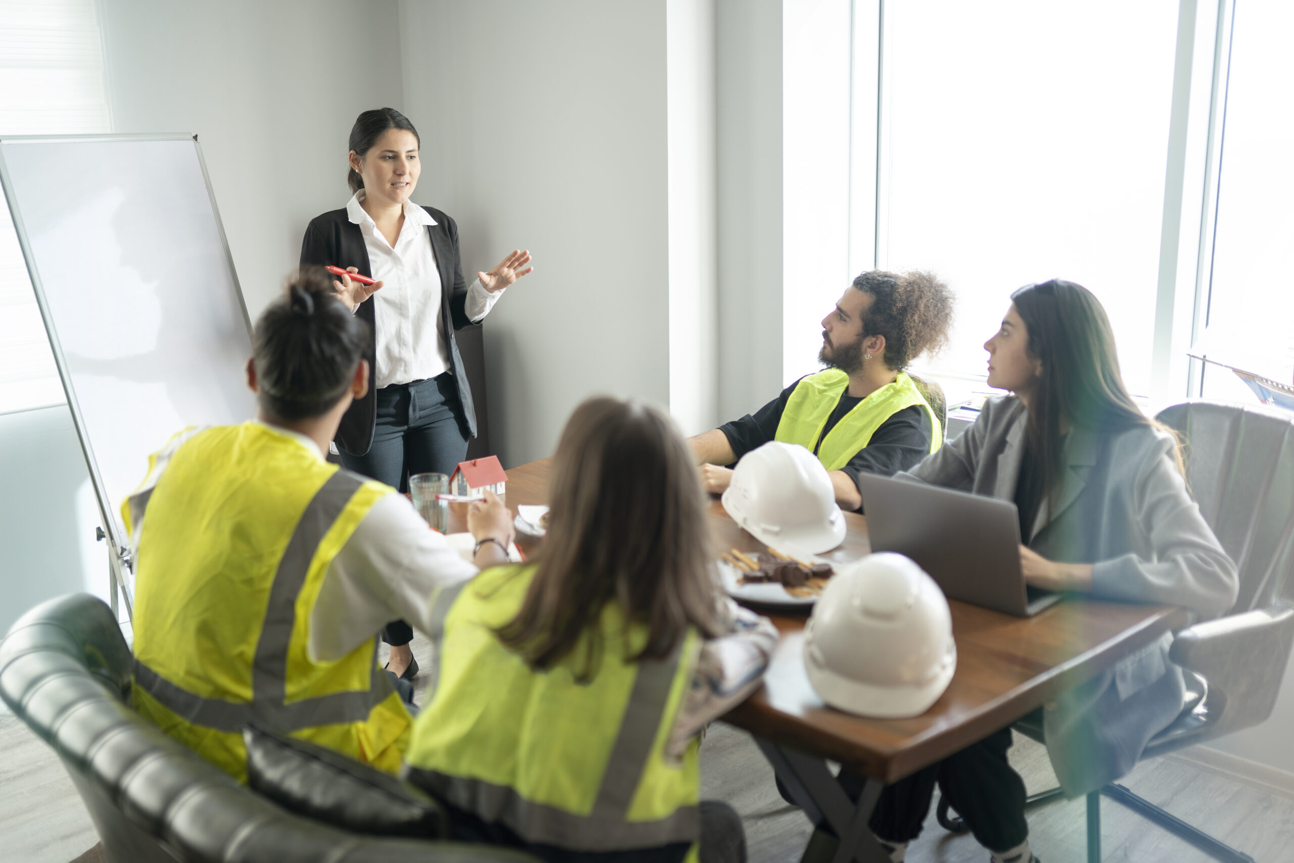 Team meeting discussing workplace safety protocols and risk awareness.