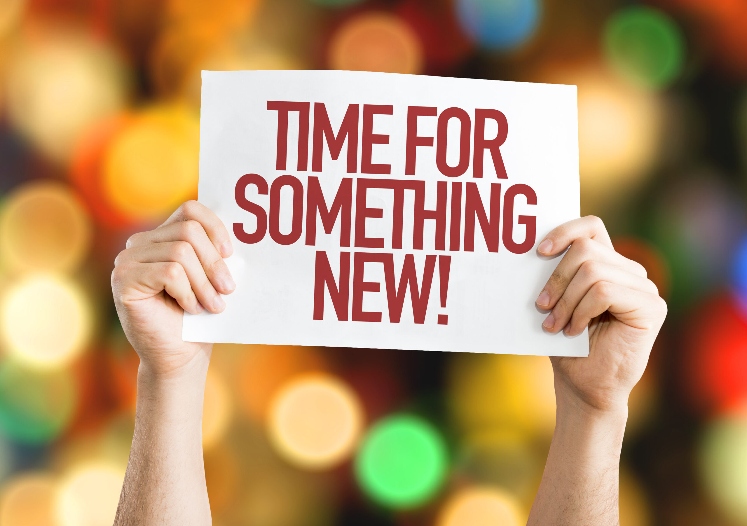 Hands holding sign reading "Time for something new" promoting career change and RISSafety opportunities.