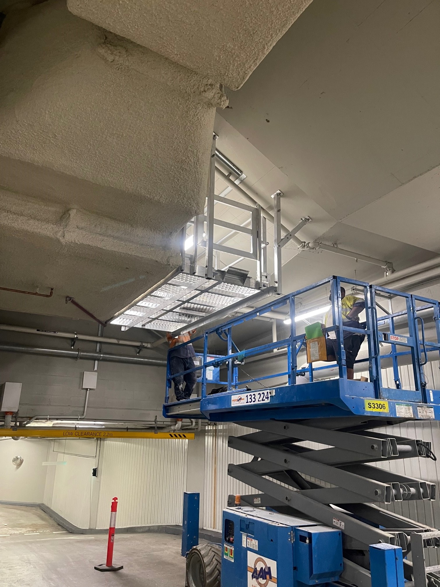 RISSafety access platform installation on 100 Mount Street, North Sydney, with maintenance workers on a scissor lift.