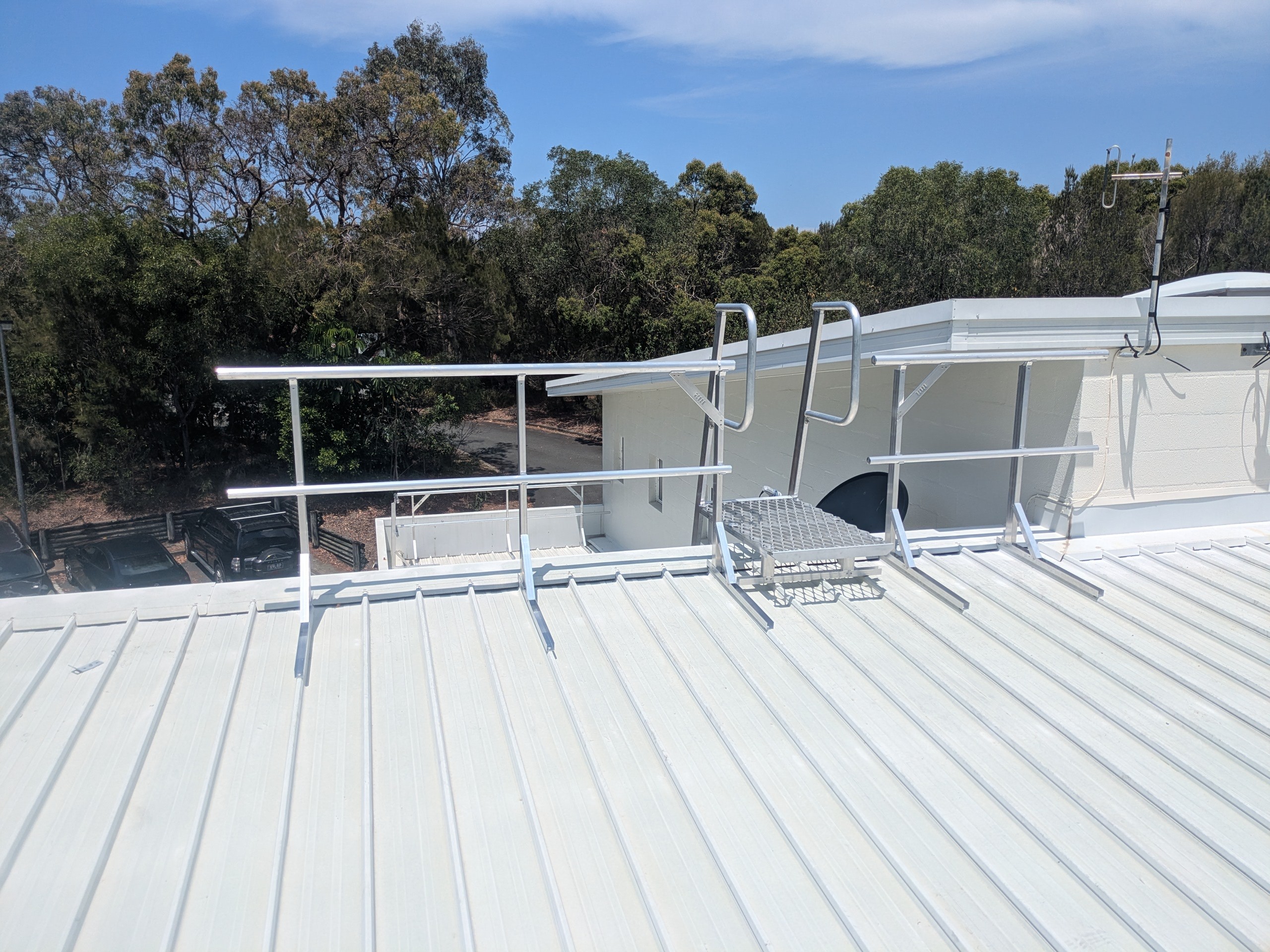 Permanent roof access platform and safety system on a commercial building.